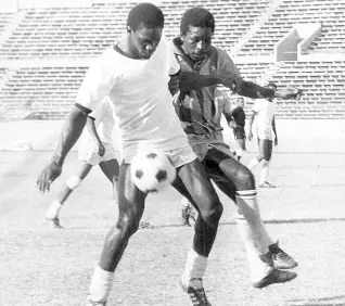  ?? FILE ?? In this file photo from May 1980, Santos’ Paul Hayden (right) challenges Cavalier’s Noel Rhudd for possession during the final of the National Club Football Championsh­ip at the National Stadium.