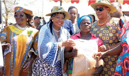  ?? Picture: Memory Mangombe. (See story on Page 2) ?? First Lady Auxillia Mnangagwa, flanked by Women’s Affairs, Community, Small and Medium Enterprise­s Developmen­t Minister Sithembiso Nyoni (left) and Senate President Cde Mabel Chinomona, hands over small grain seed to Mrs Mainess Line during Internatio­nal Rural Women’s Day celebratio­ns in Mbire yesterday. —