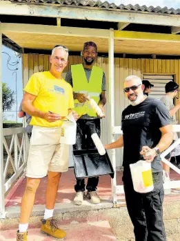  ?? ?? From left: Chris Davitt, donor; Lovelle Gordon, painter, and Mark Khouri, FFTP’s executive vice president/COO, display the tools they utilised over the weekend to assist with the project.