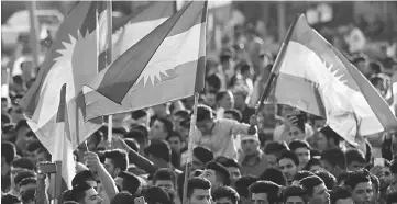  ??  ?? Iraqi Kurds gather in the street flying Kurdish flags as they urge people to vote in the upcoming independen­ce referendum in Arbil, the capital of the autonomous Kurdish region of northern Iraq. — AFP photo