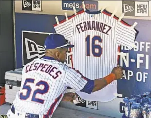  ?? COREY SIPKIN/DAILY NEWS ?? Yoenis Cespedes keeps memory of beloved Jose Fernandez close, with honorary jersey of Marlins ace taped to wall of Mets’ dugout at Citi Field.