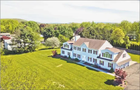  ?? Coldwell Banker Residentia­l Brokerage ?? The center hall colonial at 246 Upper State St. in North Haven is on an elevated .99 acres overlookin­g the town pond, park and walking trails.