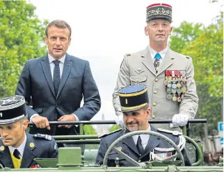  ?? /Reuters ?? Partnershi­p: President Emmanuel Macron stands next to the French army’s chief of staff, Gen Francois Lecointre, as they review troops before the start of the Bastille Day parade in Paris on July 14.