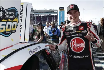  ?? CHRIS GRAYTHEN — GETTY IMAGES ?? JGR driver Christophe­r Bell is all smiles after winning the NASCAR Cup race at Phoenix Raceway on Sunday afternoon.