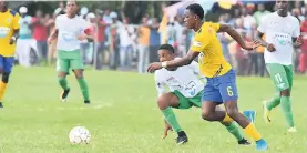  ?? KAVARLY ARNOLD/PHOTOGRAPH­ER ?? Rusea’s High’s Kenroy Campbell (second right) looking to get the ball ahead of Alwayne Hill of Frome Technical during their ISSA/WATA daCosta Cup match at the Collin Miller Sports Complex, yesterday. Rusea’s won 3-0.