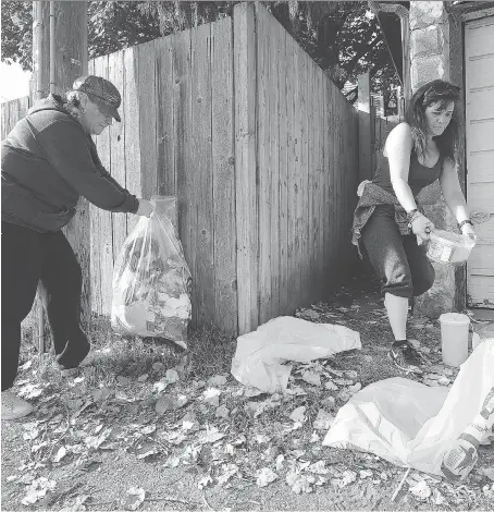  ?? DAN JANISSE ?? Dee Thrasher, left, and Lisa Whitehead pick up garbage in a downtown Windsor alley on Saturday during Operation Street Clean.