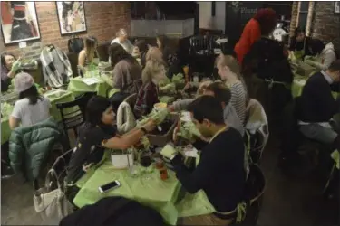  ?? TRACEE HERBAUGH VIA AP ?? A hip hop bar in downtown Boston is crowded during Plant Nite where people where there to learn the craft of terrarium building.