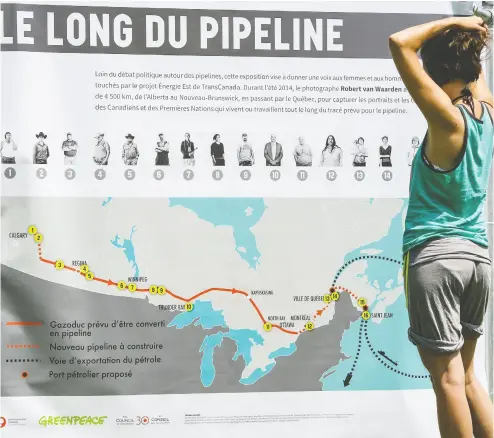  ?? FREDERIC HORE / POSTMEDIA NEWS FILES ?? Melissa Lachance of Montreal looks at a map of the proposed Energy East pipeline at a rally in 2015 organized by Greenpeace and other groups opposed to the project. The reality is that, whether the environmen­talists like it or not,
demand for oil will persist for decades to come and Canada’s oil and gas will be needed, Diane Francis writes.