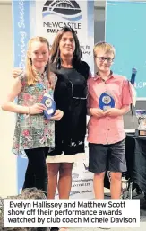  ??  ?? Evelyn Hallissey and Matthew Scott show off their performanc­e awards watched by club coach Michele Davison