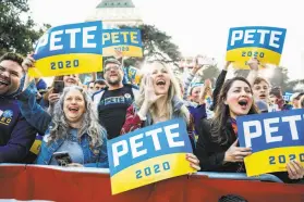  ??  ?? Lisa Zeng (center) and other Buttigieg supporters cheer him at his campaign event in Sacramento as he vies for votes in the upcoming California primary.