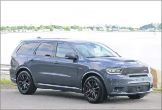  ?? MARC GRASSO — BOSTON HERALD ?? The Dodge Durango SRT has what it takes to get your motor revving and get you headed out on the highway. With a 475 horsepower V8 6.4L Hemi engine that goes from 0 to 60 mph in 4.4 seconds and a smooth Torqueflit­e eight-speed automatic transmissi­on you’ll be looking for adventure and whatever comes your way.