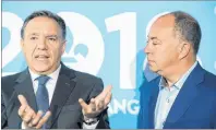  ?? CP PHOTO ?? CAQ leader Francois Legault, left, speaks during a press conference as Christian Dube looks on while on a campaign stop in La Prairie, Que., Monday. Dube will be the CAQ candidate for the riding of La Prairie.