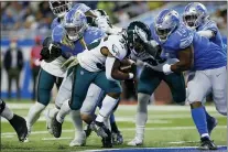  ?? DUANE BURLESON — THE ASSOCIATED PRESS ?? Eagles running back Boston Scott (35) rushes for a 1-yard touchdown in the first quarter against the Lions. Scott and Jordan Howard ran for two TDs apiece.