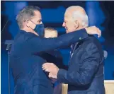  ?? ANDREW HARNIK/AP ?? President-elect Joe Biden embraces his son Hunter Nov. 7 in Wilmington, Delaware. Federal prosecutor­s are investigat­ing Hunter Biden’s tax affairs.