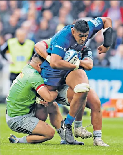  ??  ?? Full force: Will Skelton, who scored two tries in Saracens’ second-half comeback, is tackled by Harlequins’ Lewis Boyce