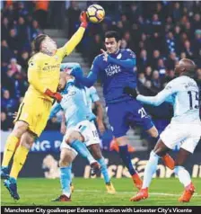  ??  ?? Manchester City goalkeeper Ederson in action with Leicester City’s Vicente Iborra during yesterday’s English Premier League match at the King Power Stadium. – REUTERSPIX