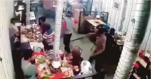  ??  ?? A clip of the video which shows six armed men robbing a restaurant in Taman Melawati, Kuala Lumpur, on Saturday.