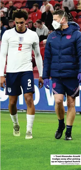  ?? Peter Powell/Getty Images ?? > Trent Alexander-Arnold trudges away after picking up an injury against Austria