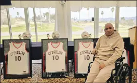  ?? GRETCHEN GRIERSON / SPECIAL TO THE SUN ?? UNLV basketball great and longtime broadcaste­r Robert Smith sits in the Boulder Creek Golf Club clubhouse next to framed jerseys featuring his No. 10 from his playing days with the Rebels. The jerseys were prizes for winners participat­ing in a golf tournament and birthday celebratio­n for Smith, who turned 69 on Sunday. The golf tournament proceeds will help Smith with expenses for physical therapy, which he continues to undergo after suffering a stroke five years ago.