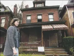  ??  ?? Marlee Gallagher, press coordinato­r of Wilkinsbur­g Community Developmen­t Corporatio­n, stops at 816 South St. in Wilkinsbur­g, which will be shown on the tour.