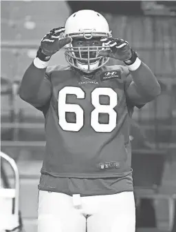  ?? ROB SCHUMACHER/THE REPUBLIC/USA TODAY NETWORK ?? Cardinals offensive tackle Kelvin Beachum (68) stretches during training camp at State Farm Stadium last week.