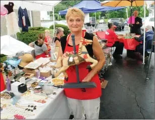  ?? Ernest A. Brown photo ?? Mary Gudz, of Woonsocket, a church volunteer and parishione­r, shows off one of many gifts available at the gift table during the annual Polish Festival at St. Stanislaus Catholic Church in Woonsocket Saturday.