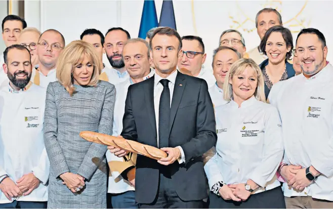  ?? ?? Emmanuel Macron with his wife, Brigitte, far left, at a traditiona­l epiphany cake ceremony at the Elysée in Paris
