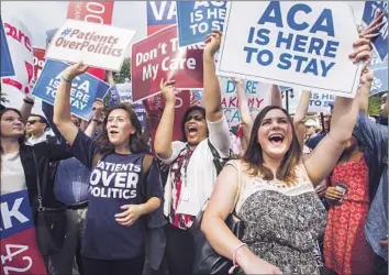  ?? Ji m Lo Scalzo European Pressphoto Agency ?? SUPPORTERS of the Affordable Care Act cheer outside the Supreme Court after justices ruled 6 to 3 that the healthcare law’s tax credits can go to residents of any state.