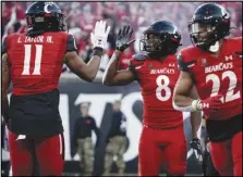  ?? Associated Press ?? Cincinnati wide receiver Michael Young Jr. (8) celebrates with tight end Leonard Taylor (11) after scoring a touchdown during the second half against Tulsa on Saturday in Cincinnati.