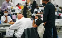  ?? BRITTANY GREESON/NEW YORK TIMES FILE PHOTO ?? Election workers count ballots in Detroit in November. For years, Republican­s have used the specter of cheating as a reason to impose barriers to ballot access. A definitive debunking of claims of wrongdoing in 2020 has not changed that message.