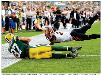  ?? STACY REVERE / GETTY IMAGES ?? The Packers’ Jordy Nelson (left) catches a touchdown pass with 17 seconds left in regulation at Lambeau Field in Green Bay. The TD erased what had been a 14-point Bengals lead.