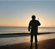  ?? JEREMIAS GONZALEZ/AP ?? A World War II reenactor pays tribute to soldiers during a D-Day commemorat­ion ceremony Monday in Saint-Laurentsur-Mer, France.