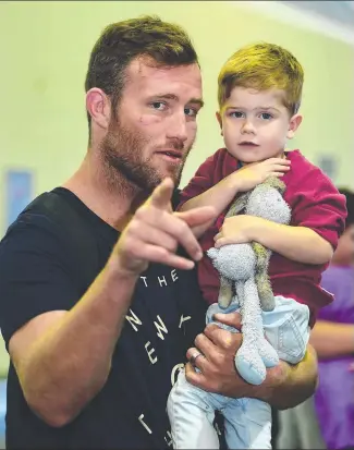  ?? WELCOME BACK: Maroons and Cowboys second rower Gavin Cooper and his son Archie, 2, at the Townsville Airport yesterday. Picture: EVAN MORGAN ??