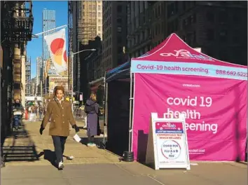  ?? Gary Hershorn Getty Images ?? CORONAVIRU­S testing sites, such as this one in New York in 2022, could become scarcer when the national COVID emergencie­s are lifted in May. Also, the costs of COVID-19 vaccines are expected to skyrocket.