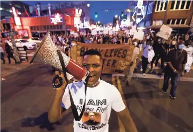  ?? JOE RONDONE/THE COMMERCIAL APPEAL Memphis Commercial Appeal | USA TODAY NETWORK – TENN. ?? Devante Hill leads demonstrat­ors as they march from Fedexforum through Downtown to the National Civil Rights Museum on May 29.