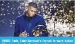  ?? — AFP ?? PARIS: Paris Saint-Germain’s French forward Kylian Mbappe receives the Best Ligue 1 Player award during a TV show on May 15, 2022, as part of the 30th edition of the UNFP (French National Profession­al Football players Union) ceremony.