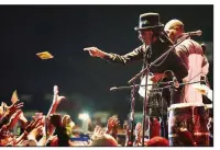  ?? AP/TSVANGIRAY­I MUKWAZHI ?? Popular Zimbabwean musician Thomas Mapfumo throws out CDs to fans during his April performanc­e in Harare, after returning from exile in the United States to perform protest songs in front of tens of thousands of people on the outskirts of the capital.