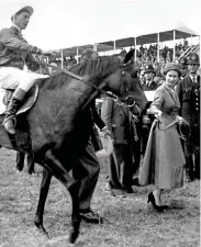  ?? ?? 1957
The Queen leads in her Oaks winner, Carrozza, with Lester Piggott — who was her favourite jockey — in the saddle