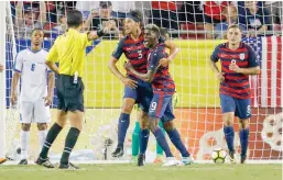  ??  ?? Omar Gonzalez (3) of the US celebrates his goal with teammate Gyasi Zardes (9) as Jordan Morris (8) looks on and Jordy Delem (8) of Martinique reacts during the second half of the CONCACAF Group B match at Raymond James Stadium on Wednesday in Tampa,...