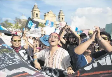  ?? Moises Castillo Associated Press ?? IN GUATEMALA CITY, protesters call for the resignatio­n of President Otto Perez Molina, who has been struggling to get ahead of twin scandals that have forced the ouster of his vice president and other officials.