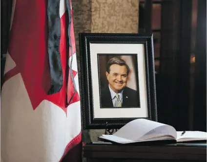  ?? FRED CHARTRAND/ THE CANADIAN PRESS ?? A book of condolence­s and a photograph of former finance minister Jim Flaherty is placed on a table at Parliament Hill on Friday.