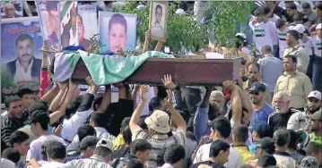 ?? Shaam News Network via Afp/getty Images ?? Killings targeting women, children: Syrians hold a funeral Tuesday in Daraa, as talks to end the violence continue.