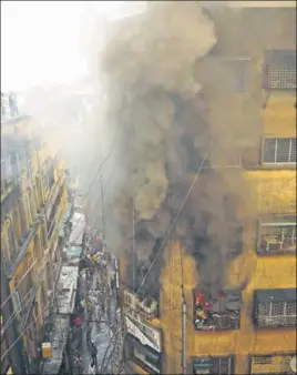  ??  ?? ■ Smoke billows out of a building in Kolkata’s Bargi Market after fire broke out in the sixstorey structure in the wee hours of Sunday. SAMIR JANA/HT