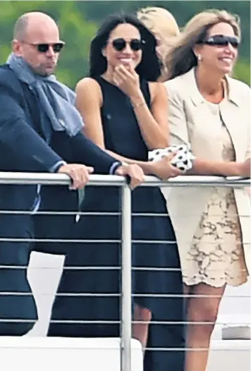  ??  ?? Meghan Markle wore an elegant blue dress and sunglasses as she cheered on her boyfriend, Prince Harry, at the polo