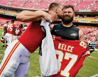  ?? David Maialetti/Tribune News Service ?? Kansas City tight end Travis Kelce, left, plants a kiss on the cheek of his brother, Eagles center Jason Kelce after a 2017 game. The two will face each other again on Sunday.