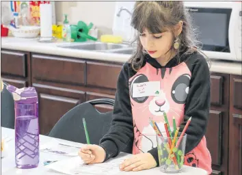  ?? CAROLE MORRIS-UNDERHILL ?? Eight-year-old Annabelle Cull, of Falmouth, wasted no time jotting down clues for a leprechaun-themed scavenger hunt.