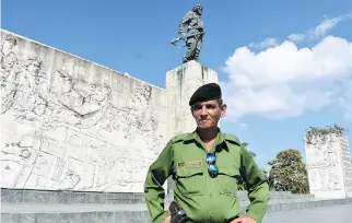  ?? PHOTOS: BARBARA TAYLOR ?? Affable police offer Eliecer poses atop Santa Clara’s impressive tribute to Cuban Revolution hero Ernesto (Che) Guevara, portrayed in a six-metre bronze statue.