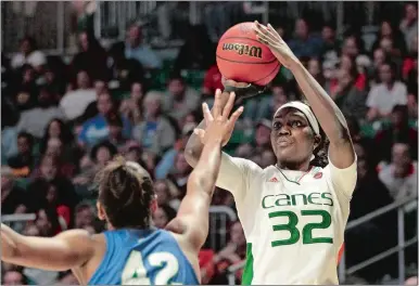  ?? LUIS M. ALVAREZ/AP PHOTO ?? In this March 22, 2019, file photo, Miami forward Beatrice Mompremier (32) shoots as Florida Gulf Coast forward Tytionia Adderly (42) defends during an NCAA tournament game in Coral Gables, Fla.