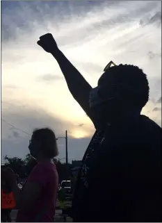  ??  ?? A demonstrat­or raises their hand in solidarity and support of “Black Lives Matter” during Upper Darby’s Community Day of Healing Wednesday evening in front of the Township Building on Garrett Road.