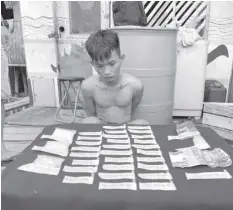  ?? D. MARANTAL ROMEO ?? Levi Abucay, 19, was arrested by the drug enforcemen­t unit of the Mambaling Police Station with 76 grams of shabu worth P516,800 during a buy-bust operation in Sitio Naba, Barangay Mambaling, Cebu City Saturday afternoon.